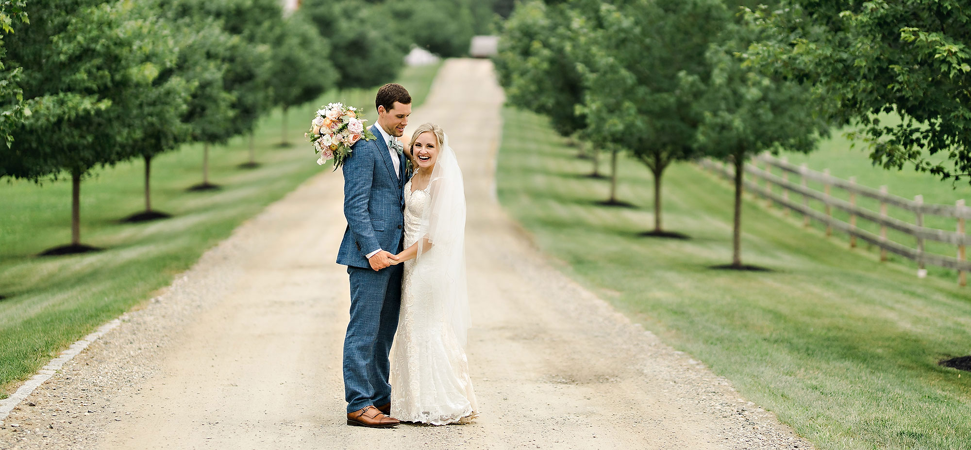 June farms wedding by elario photography bride and groom with trees on the side of the road